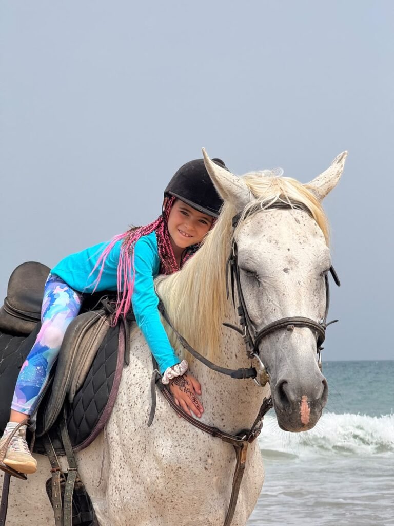 A young rider with one of our grey horses at the stable near Agadir — both horses and camels go out from here