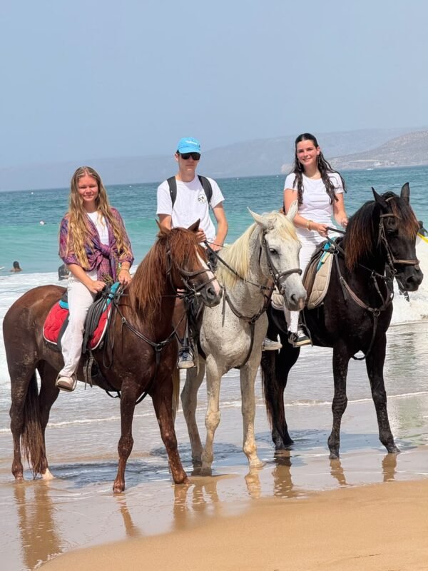 Horse and camel riding in Agadir — a group of riders setting out on horseback along the beach